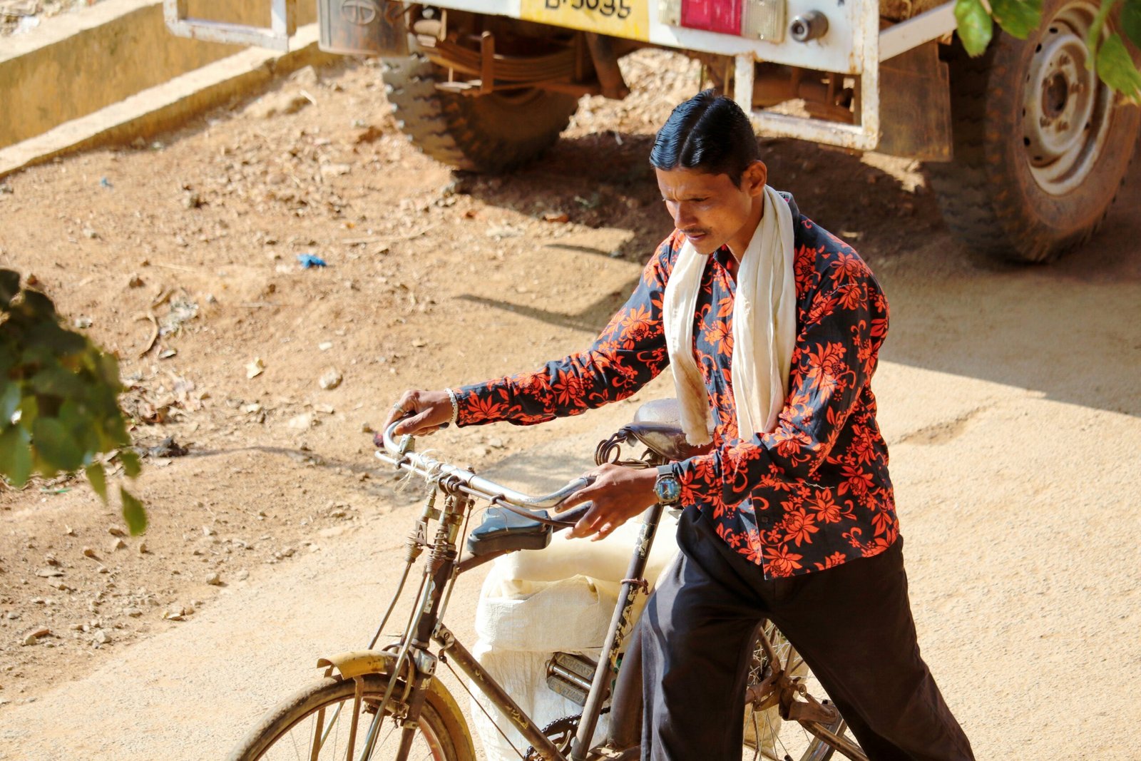 man holding bicycle on sidewalk